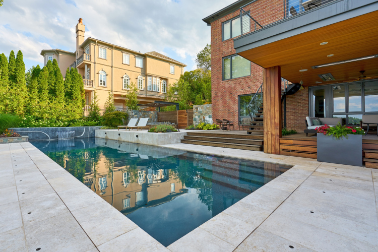 Landscape architecture blending plants, stones, and water features in Alexandria.