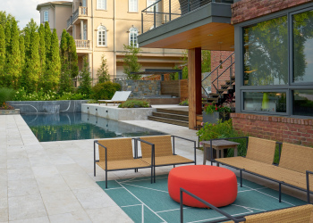 Outdoor seating area in Alexandria, overlooking the pool and landscaped surroundings.