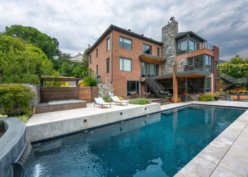 Another view of the landscaped backyard in Alexandria, with a pool as the centerpiece.