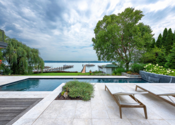 Outdoor seating area overlooking the pool and ocean