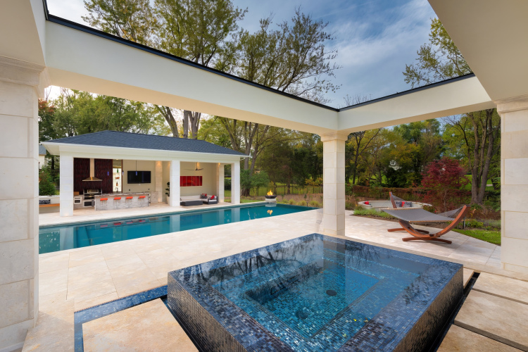 Expansive pool patio with multiple seating areas,