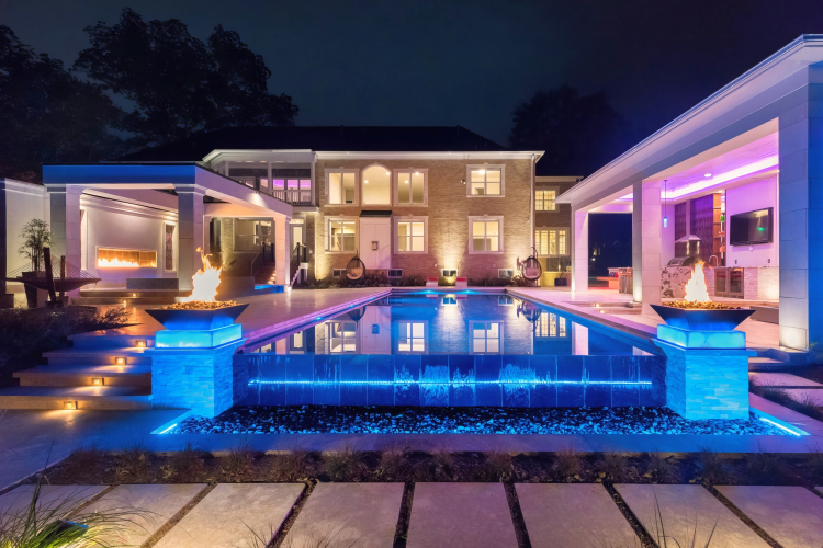 Landscape lighting highlighting the pool area, creating an enchanting ambiance in the evening.