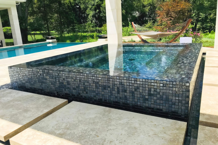 Pavilion with an infinity hot tub, offering a serene retreat