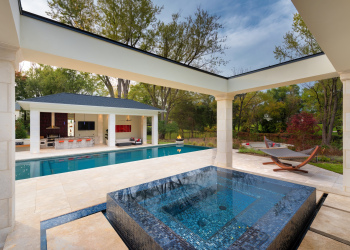 Expansive pool patio with multiple seating areas,