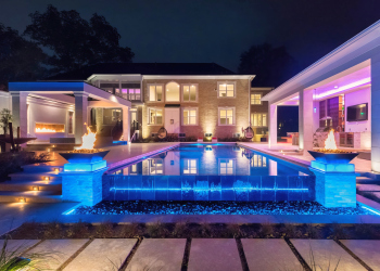 Landscape lighting highlighting the pool area, creating an enchanting ambiance in the evening.