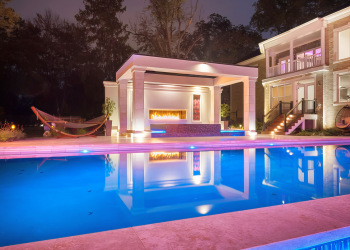 Custom pool with custom landscape lighting in McLean