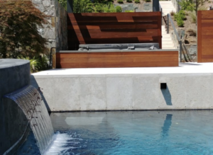 Waterfall feature into pool design in Aldie, VA