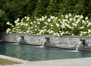 Water fall features into a custom pool design in McLean, VA