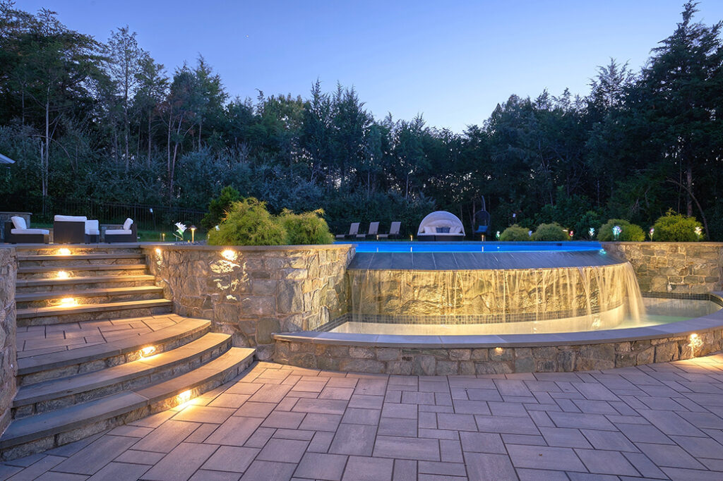 infinity pool, tub and backyard