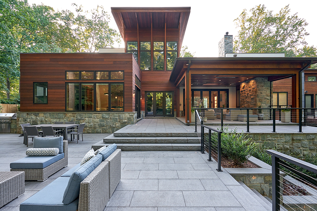 contemporary back stone sitting area by a Custom Deck Builder in Leesburg, VA